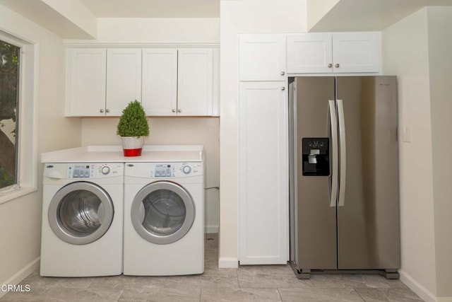 washroom featuring cabinets and washing machine and clothes dryer