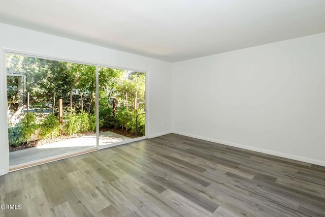 unfurnished room with hardwood / wood-style floors