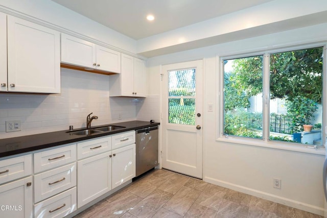 kitchen featuring dishwasher, decorative backsplash, white cabinetry, and sink