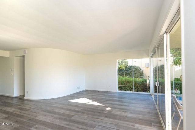 unfurnished room featuring dark hardwood / wood-style floors