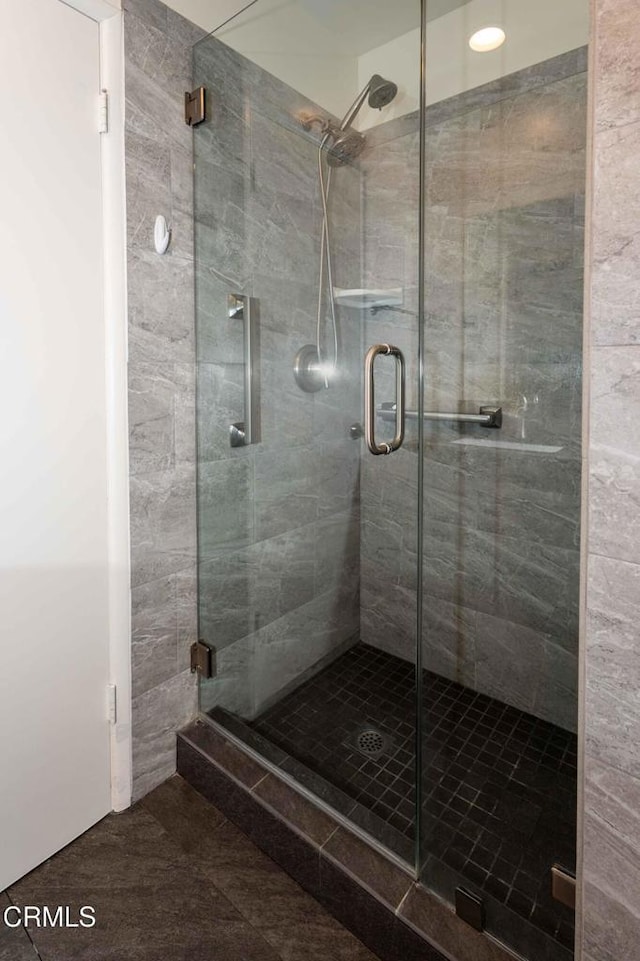 bathroom with a shower with door