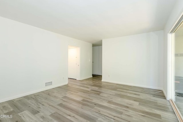 unfurnished room with light wood-type flooring