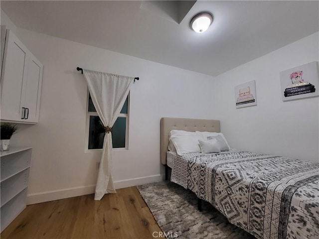 bedroom with hardwood / wood-style floors