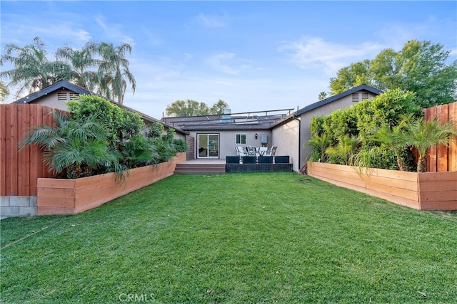 rear view of property featuring a lawn