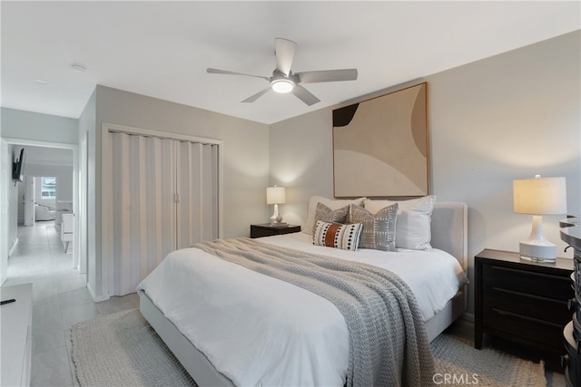 tiled bedroom with ceiling fan