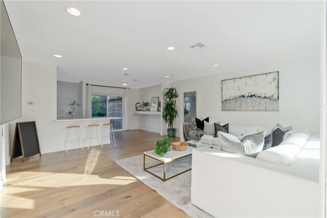 living room with light hardwood / wood-style flooring