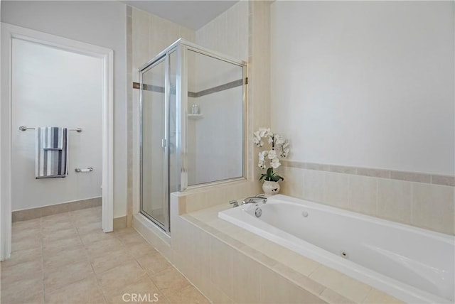 bathroom featuring tile patterned flooring and separate shower and tub