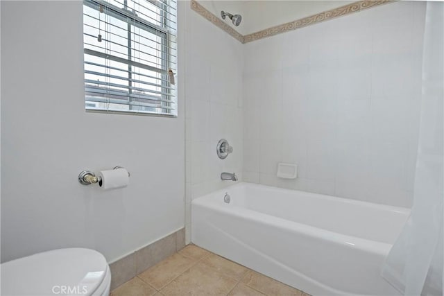 bathroom with tile patterned flooring, shower / bath combo, and toilet