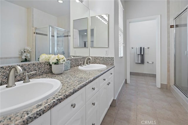 bathroom with tile patterned floors, vanity, and walk in shower