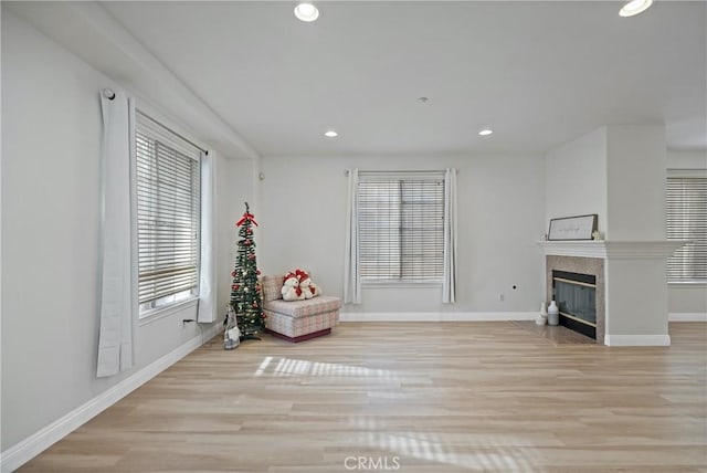 unfurnished room featuring a fireplace and light hardwood / wood-style flooring