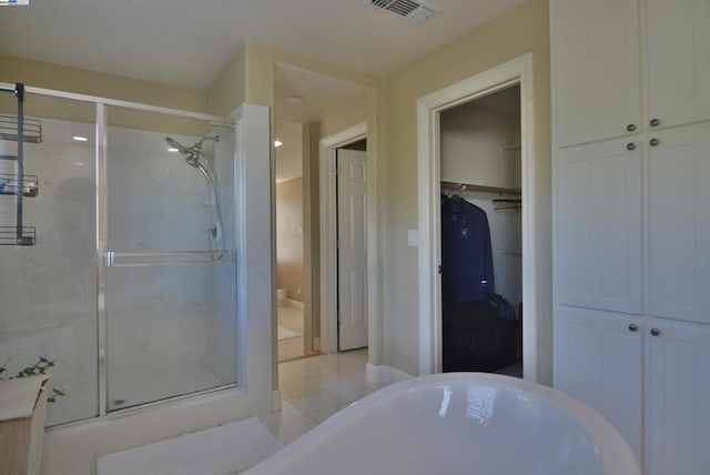 bathroom featuring tile patterned flooring and a shower with shower door