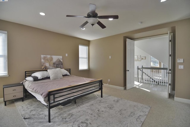 bedroom with ceiling fan and light colored carpet