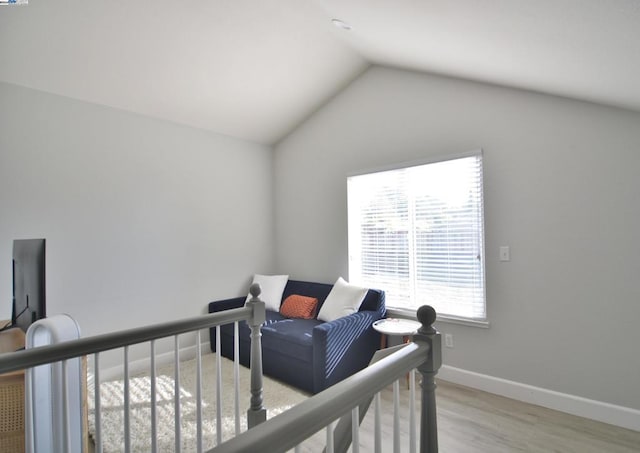 bedroom featuring light hardwood / wood-style flooring and lofted ceiling