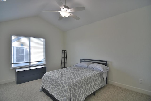 bedroom with ceiling fan, carpet floors, and vaulted ceiling