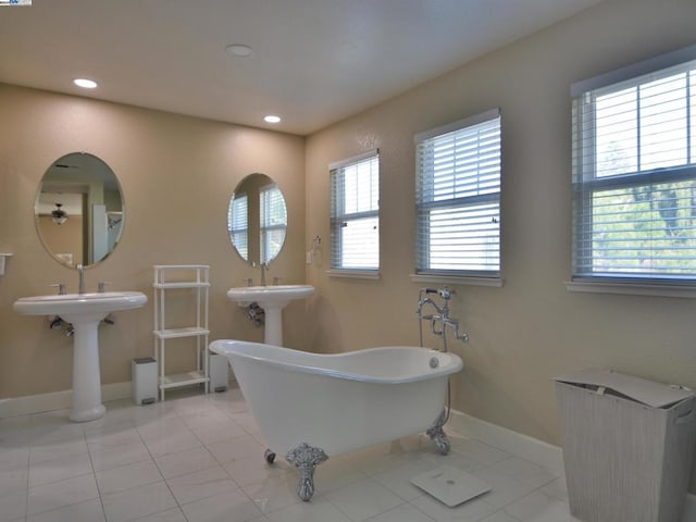 bathroom with a bathtub and double sink