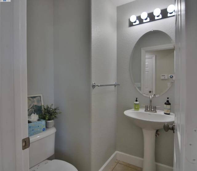 bathroom featuring tile patterned flooring and toilet