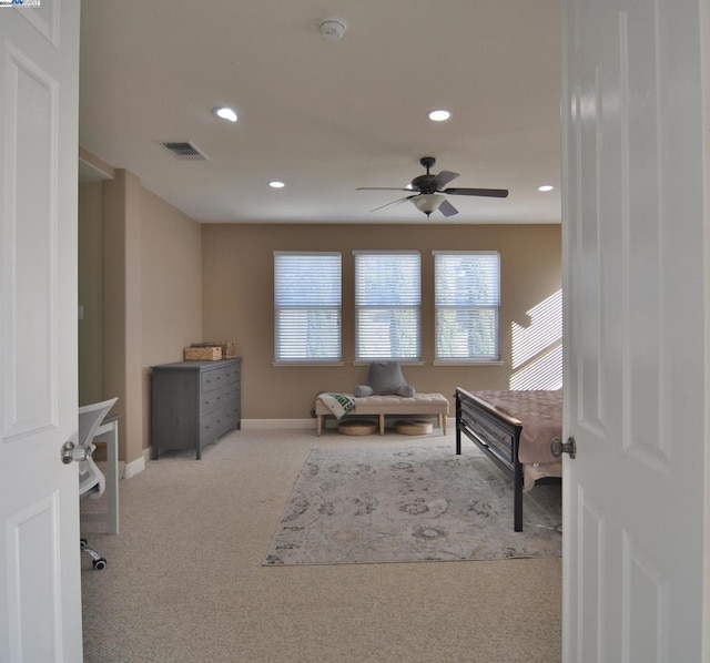 bedroom featuring light colored carpet and ceiling fan