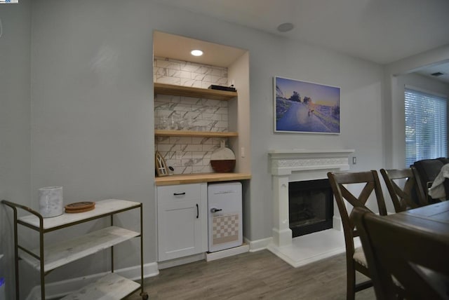 interior space featuring backsplash, white cabinets, dark hardwood / wood-style floors, and wood counters