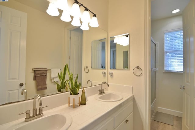 bathroom featuring a shower, wood-type flooring, and vanity