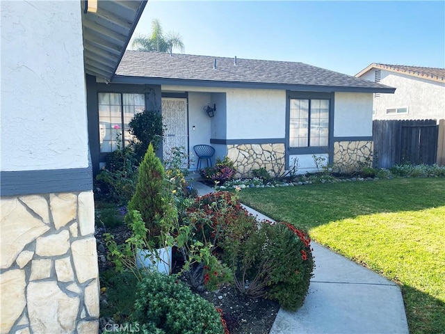 entrance to property featuring a yard