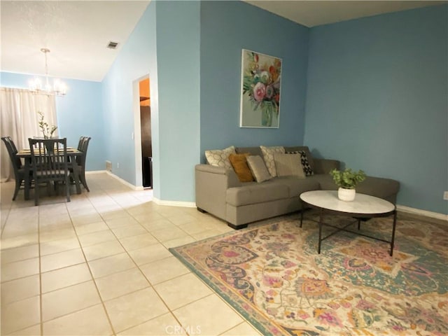 living room with a chandelier, vaulted ceiling, and light tile patterned flooring