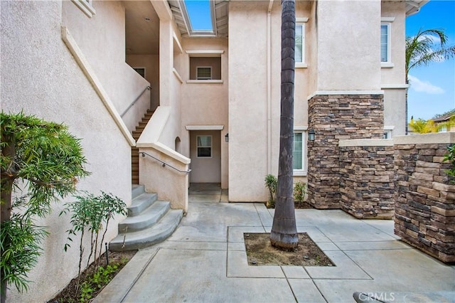 property entrance featuring a patio