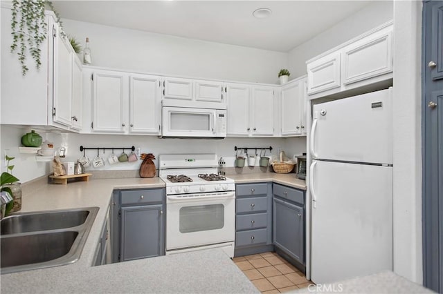 kitchen with white cabinets, gray cabinets, white appliances, and sink