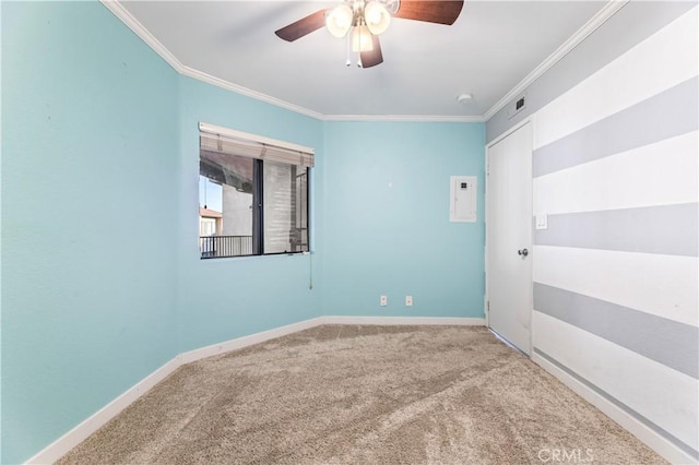 carpeted spare room featuring ceiling fan and ornamental molding