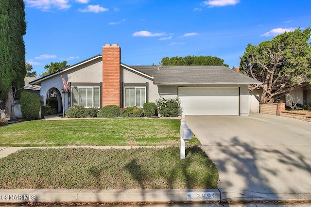 ranch-style home with a garage and a front lawn