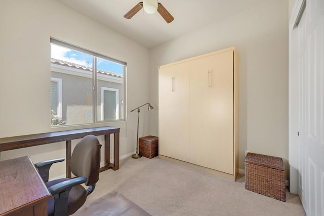 office area featuring light carpet and ceiling fan