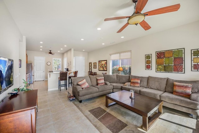 living room with ceiling fan and light tile patterned floors