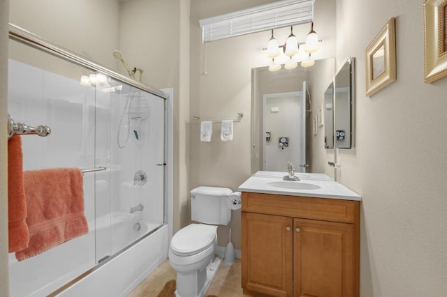 full bathroom with combined bath / shower with glass door, vanity, and toilet