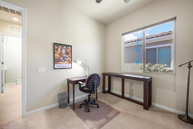 office space featuring light carpet and ceiling fan