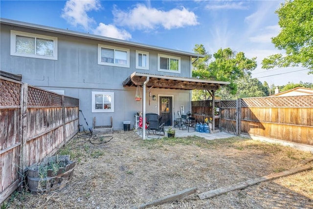 rear view of property featuring a patio