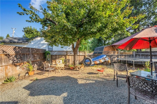 view of jungle gym featuring a trampoline and a patio area