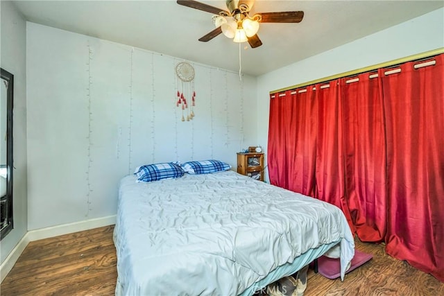 bedroom with ceiling fan and dark wood-type flooring