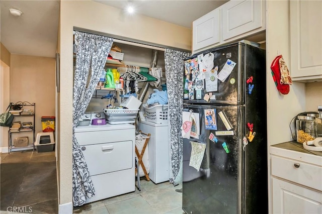 washroom with washing machine and dryer and light tile patterned flooring