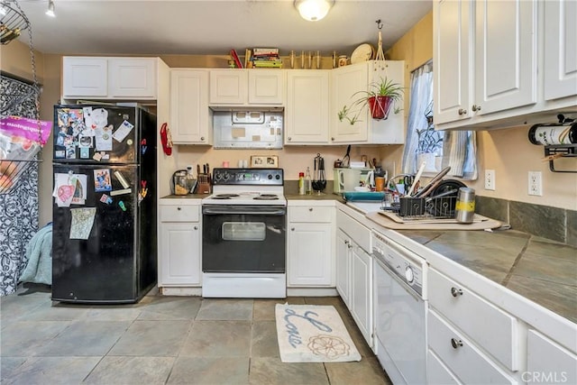 kitchen with white cabinetry, tile counters, and white appliances