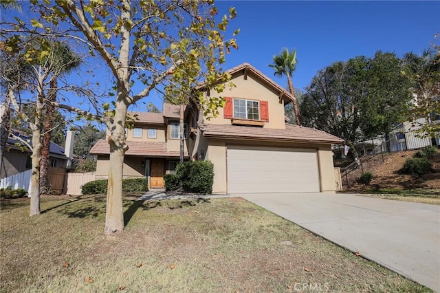 view of property featuring a garage and a front yard