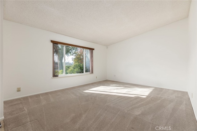 spare room featuring carpet floors and a textured ceiling