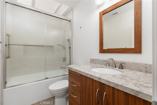 full bathroom featuring vanity, toilet, and enclosed tub / shower combo