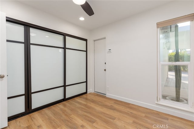 unfurnished bedroom featuring light hardwood / wood-style flooring and ceiling fan