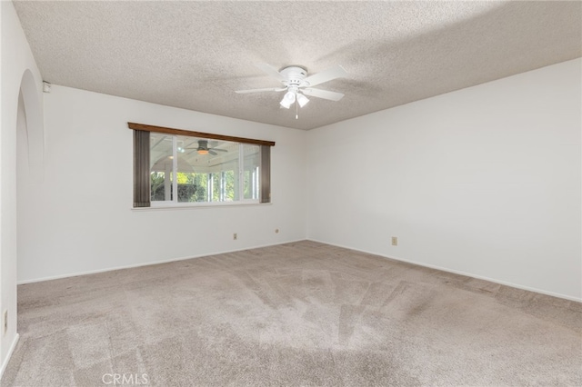 carpeted empty room featuring a textured ceiling and ceiling fan