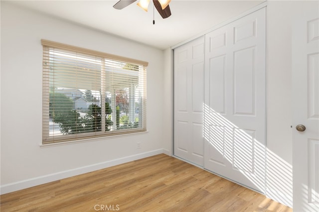 interior space with a closet, light hardwood / wood-style flooring, and ceiling fan