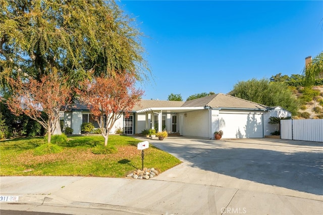 ranch-style house featuring a front yard and a garage