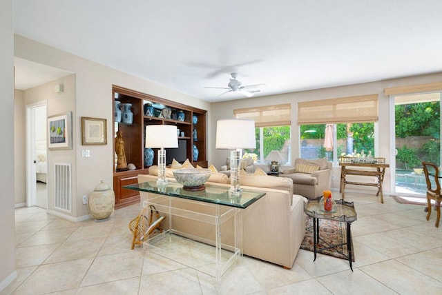 living room featuring ceiling fan, a healthy amount of sunlight, and light tile patterned floors