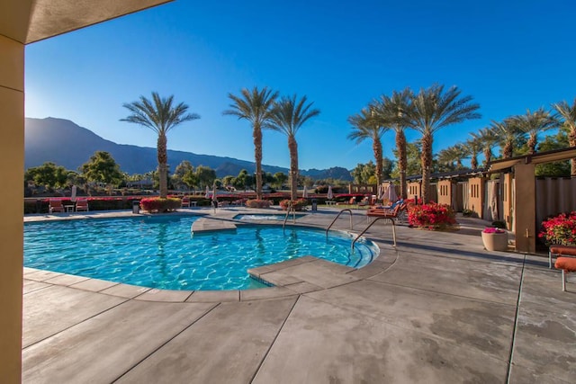 view of swimming pool featuring a mountain view and a patio