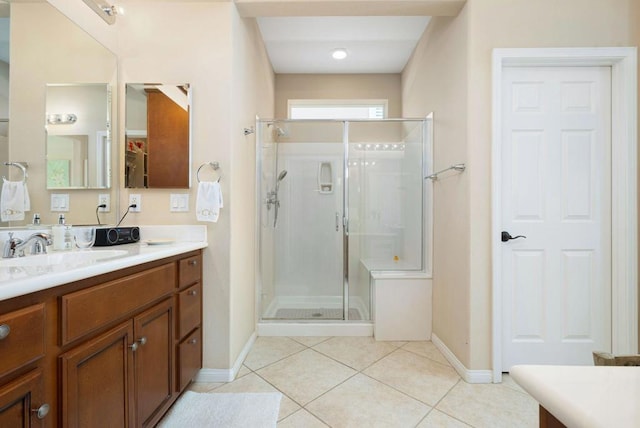 bathroom with vanity, an enclosed shower, and tile patterned floors