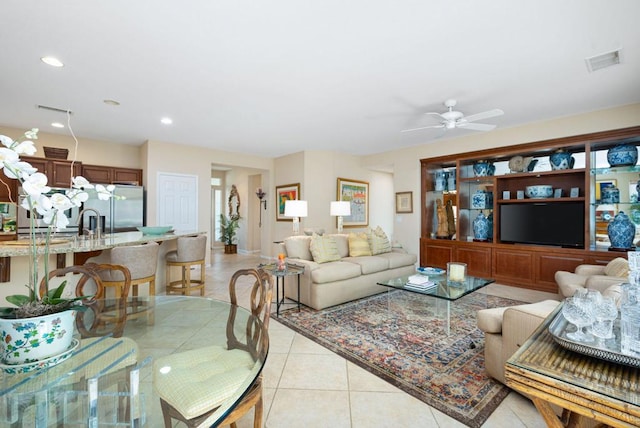 tiled living room featuring ceiling fan