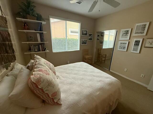 bedroom featuring ceiling fan, a closet, and carpet